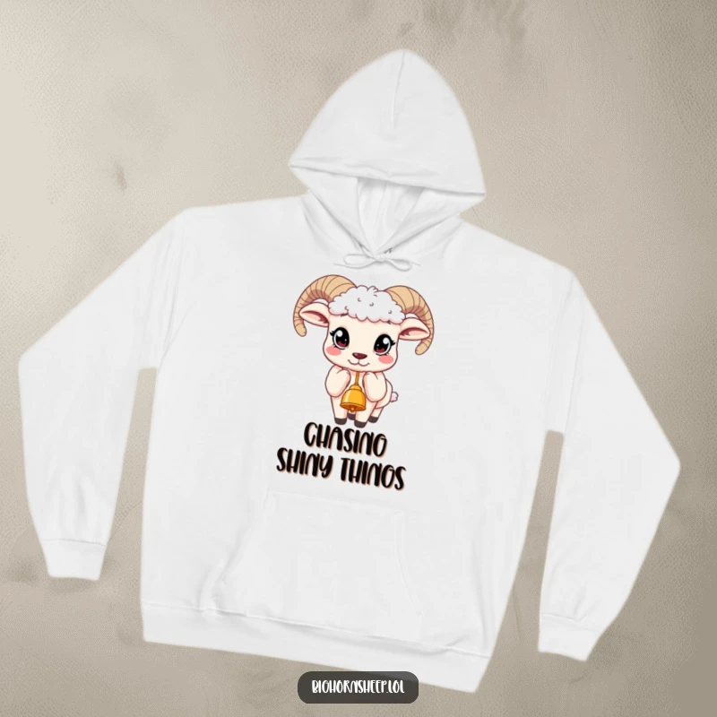 Funny hoodie depicting a bighorn sheep with enormous, curious eyes, its mouth slightly open as it reaches for a tempting bell.