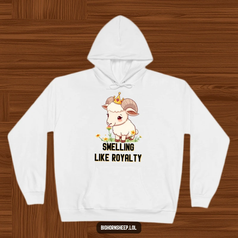 Funny Crowned Sheep Hoodie: Curious sheep with a tiny crown sniffs a wildflower, offering warmth and gentle inspiration.