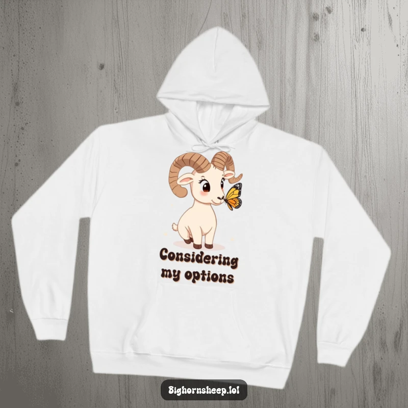 Funny bighorn sheep hoodie, head tilted curiously at a butterfly, offering a cozy and humorous design for thoughtful souls.