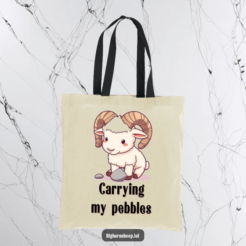 Funny tote bag showcasing a playful bighorn sheep gently butting horns with a small pebble, a humorous accessory.